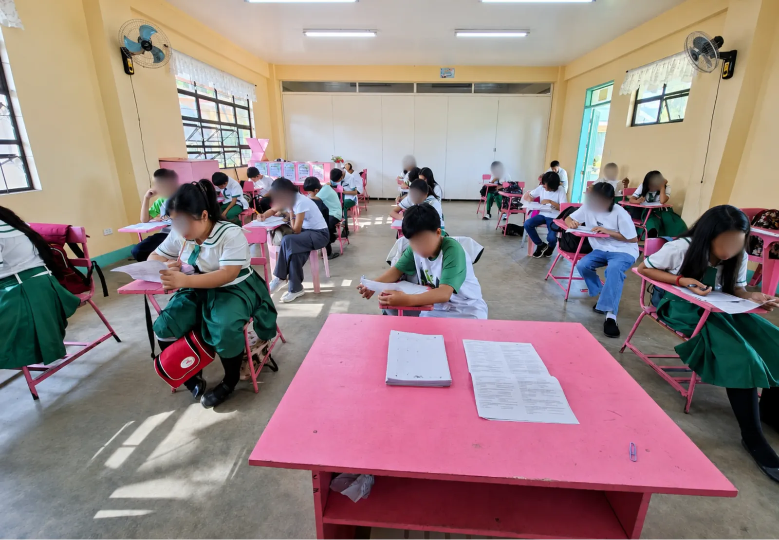 Students in a Philippine classroom seated at desks, taking an exam using GradeChum answer sheets.