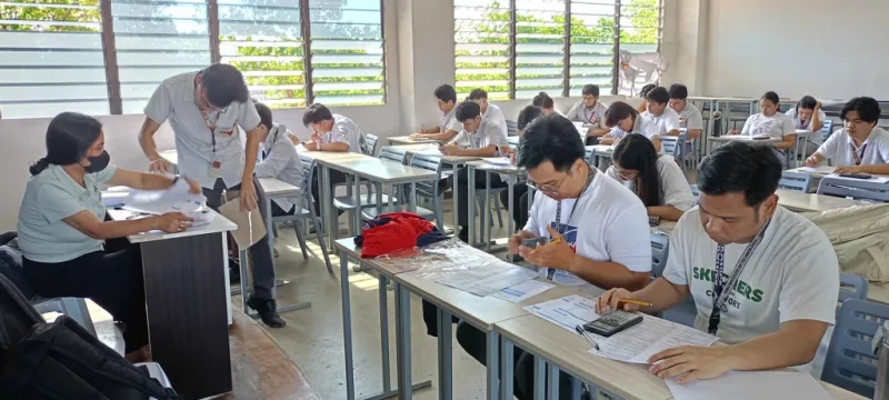 Students answering a handwritten exam that will be processed by GradeChum